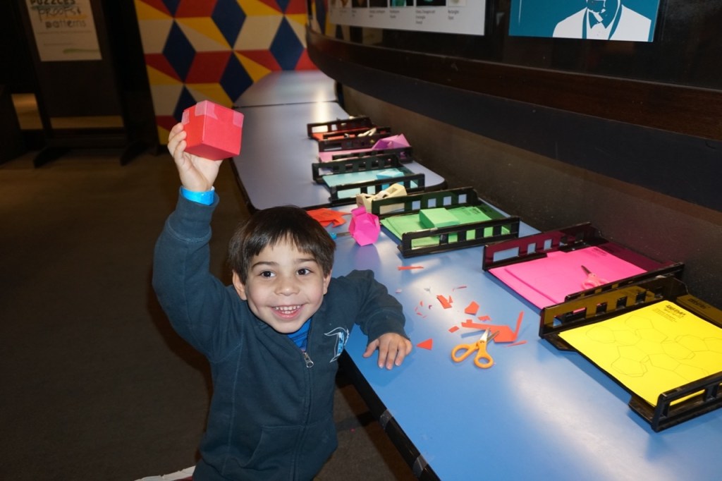 My son, proudly holding up the cube he made at Flandrau Science Center and Planetarium.