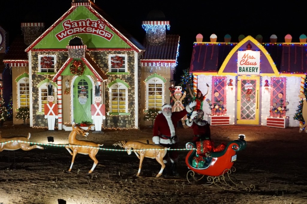 Santa and Mrs. Claus waving from the North Pole.