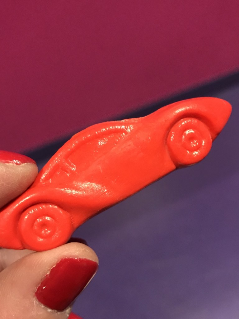 Parents and kids can make a race car out of crayon wax!