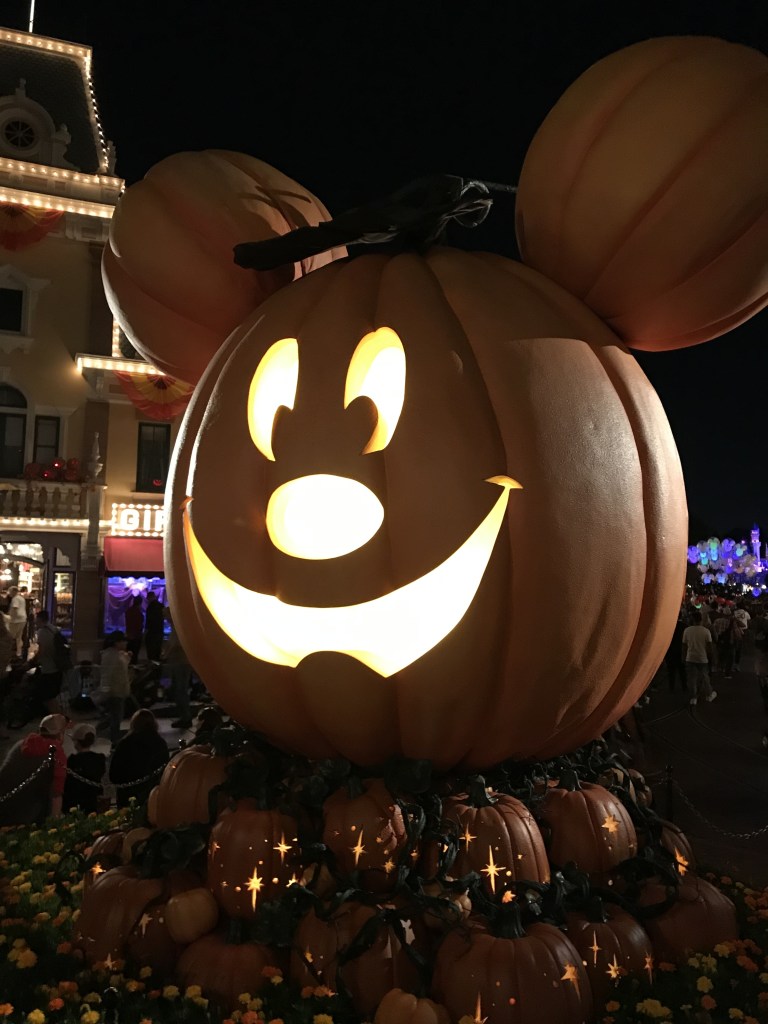 Disneyland Halloween decorations are everywhere, especially a giant pumpkin that greets guests as they enter Disneyland!